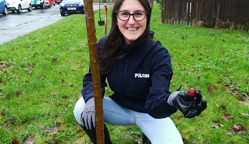 F Dita Pilon Crouching By Planted Tree