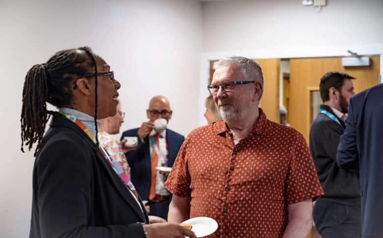 Dave Burton, Chair of the Scrutiny Panel, speaks to Geanna Bray, Board Member Responsible for Complaints