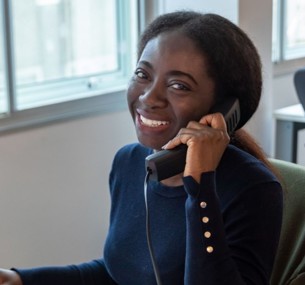image: a member of the Southern Housing customer services team answering the phone