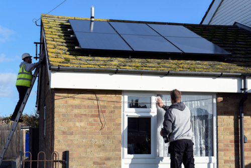 image: an engineer adding solar panels to a home