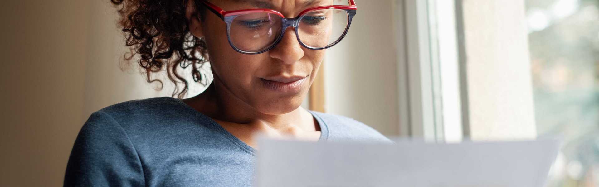 Woman reading piece of paper 