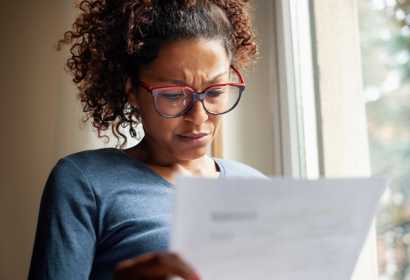 Woman reading piece of paper 