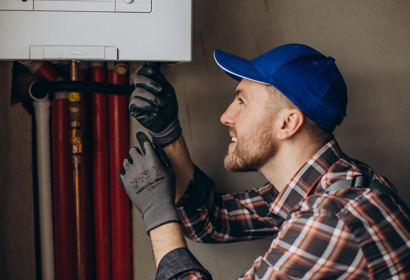 Service Man Adjusting House Heating System